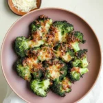 Close-up of smashed broccoli on a baking sheet.