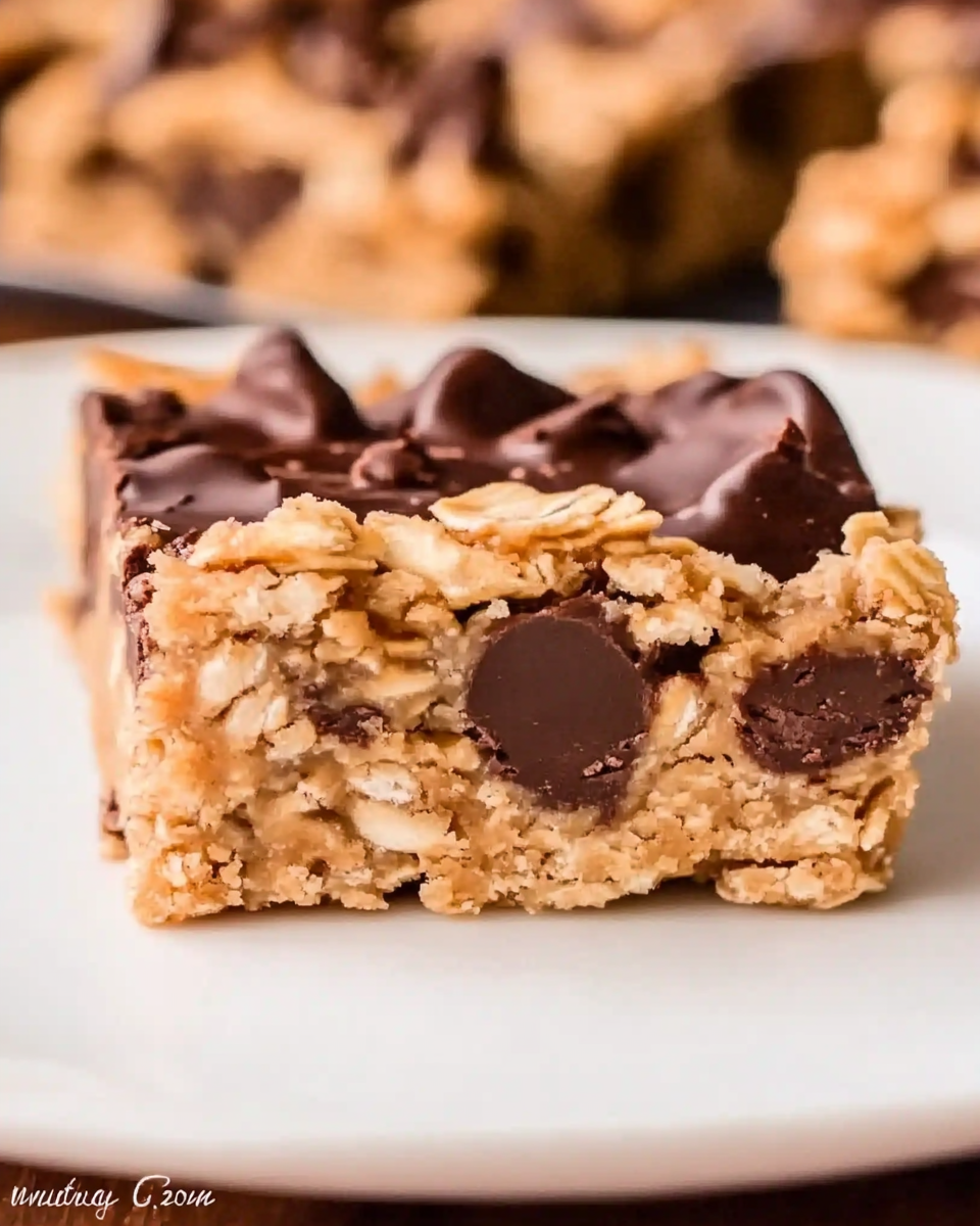 Chocolate Peanut Butter Oatmeal Bars! An easy chocolate chip cookie bar recipe with peanut butter fudge sandwiched between an oatmeal cookie crumble layer, aka Oatmeal Dream Bars!