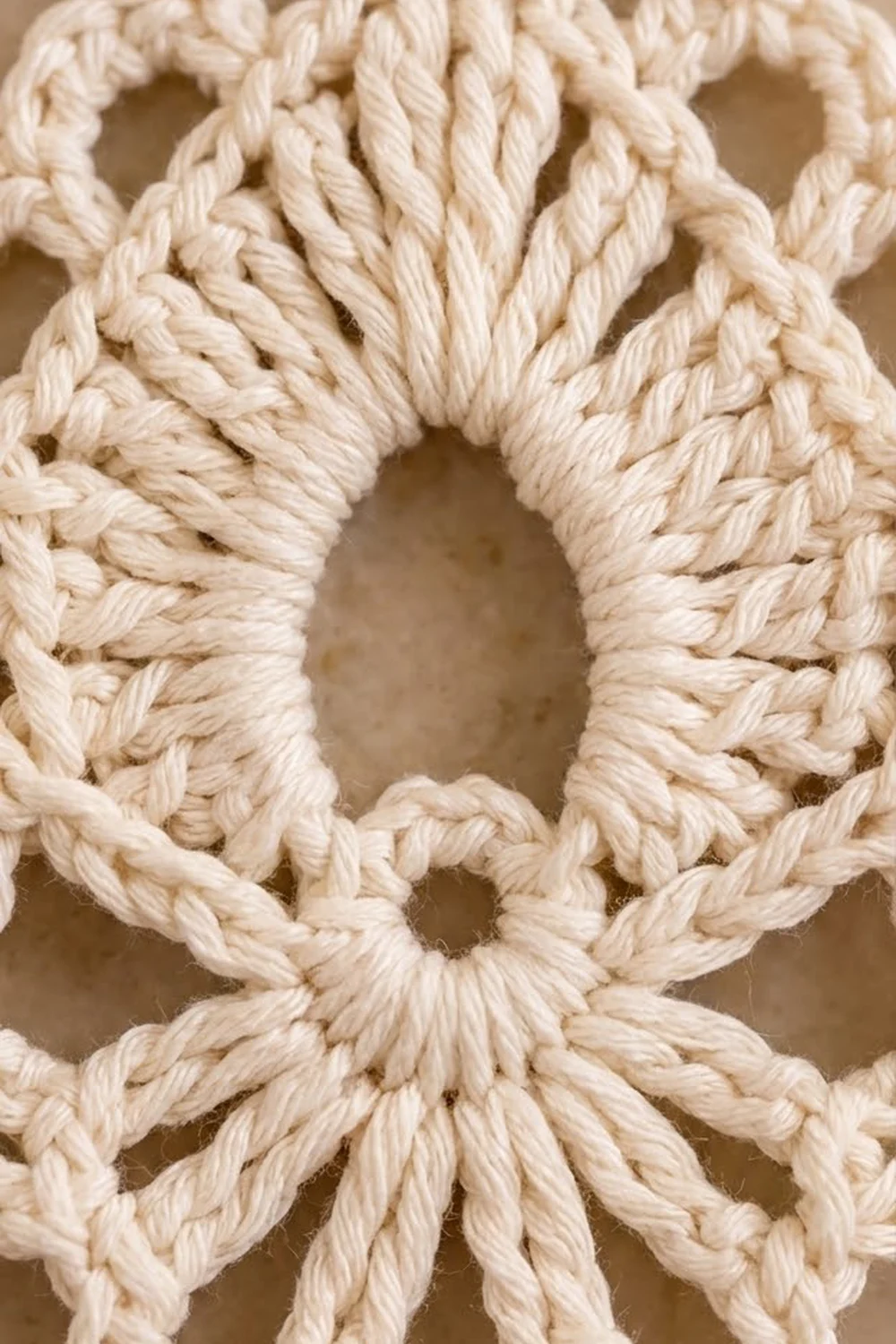 Cream crochet featuring thick twisted rope texture creating geometric dimensional patterns with distinct open spaces.