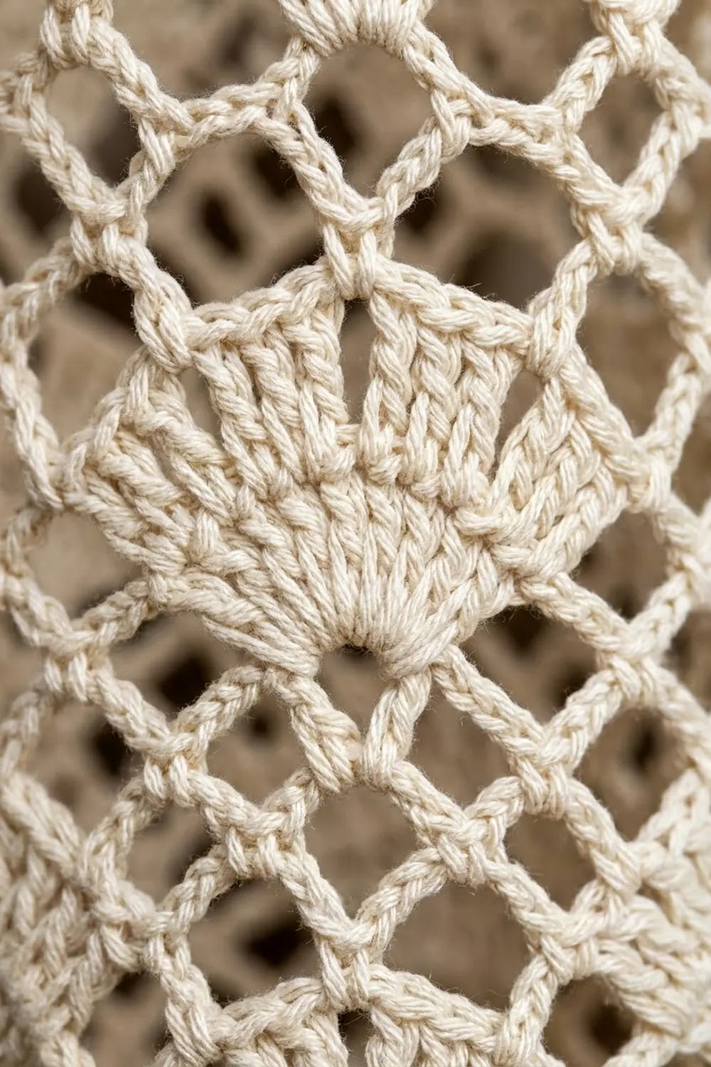 Cream twisted rope knotted in a geometric macramé lattice pattern with textured diamond details.