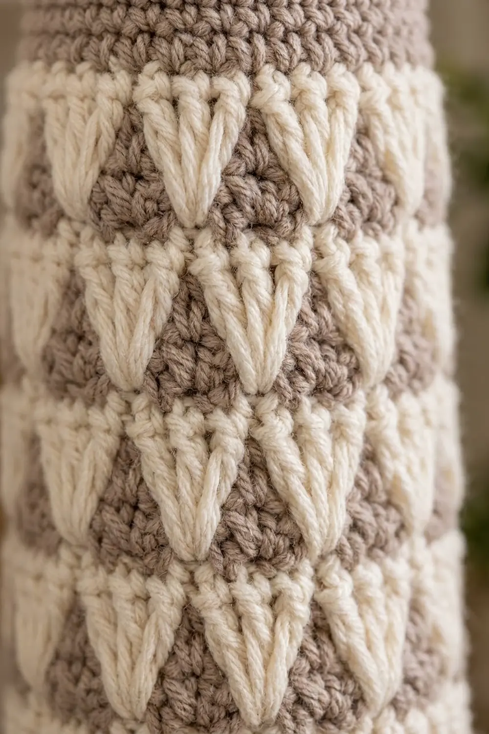 Cream and taupe crochet textile with raised vertical stitching detail creating a decorative stripe pattern.