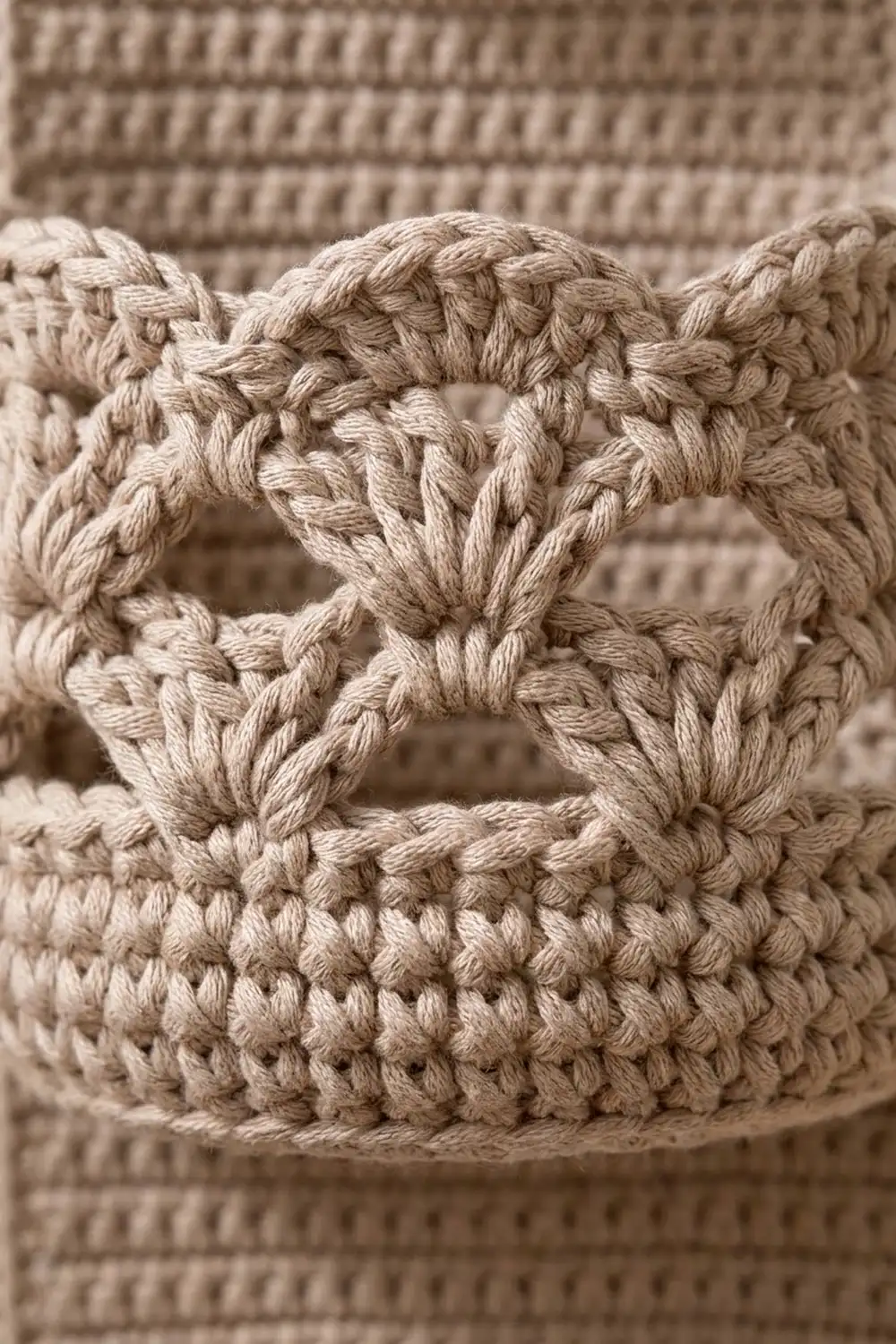 Close-up of natural crochet featuring twisted braided bands and textured repeating stitch pattern.