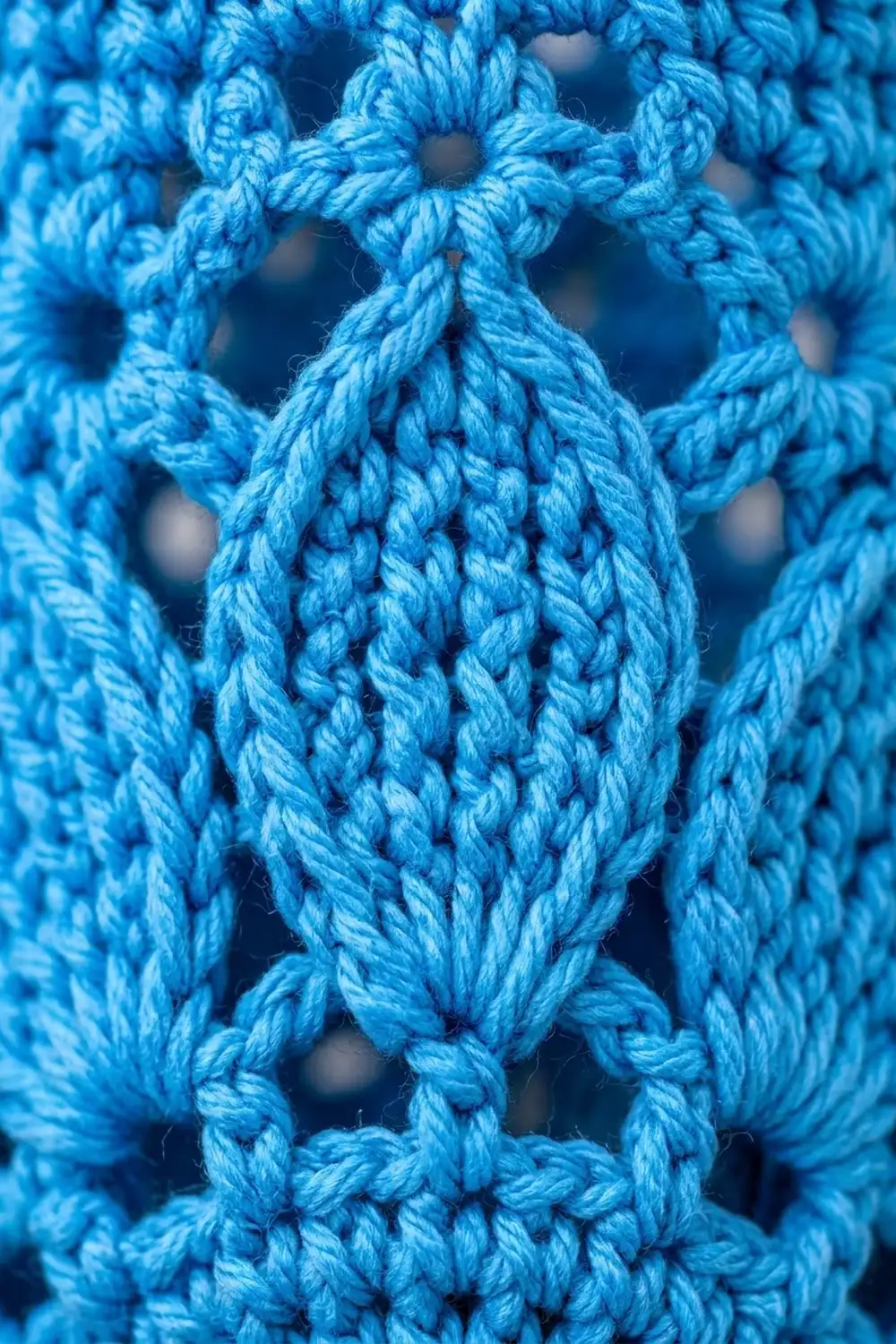 Close-up of bright blue twisted rope knots and braided strands intricately woven together.