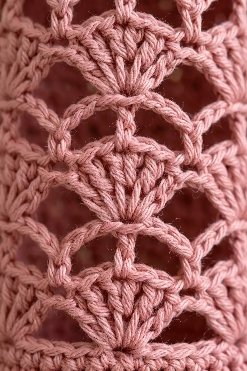 Close-up of dusty rose macramé knotwork showing detailed braided rope texture and pattern.