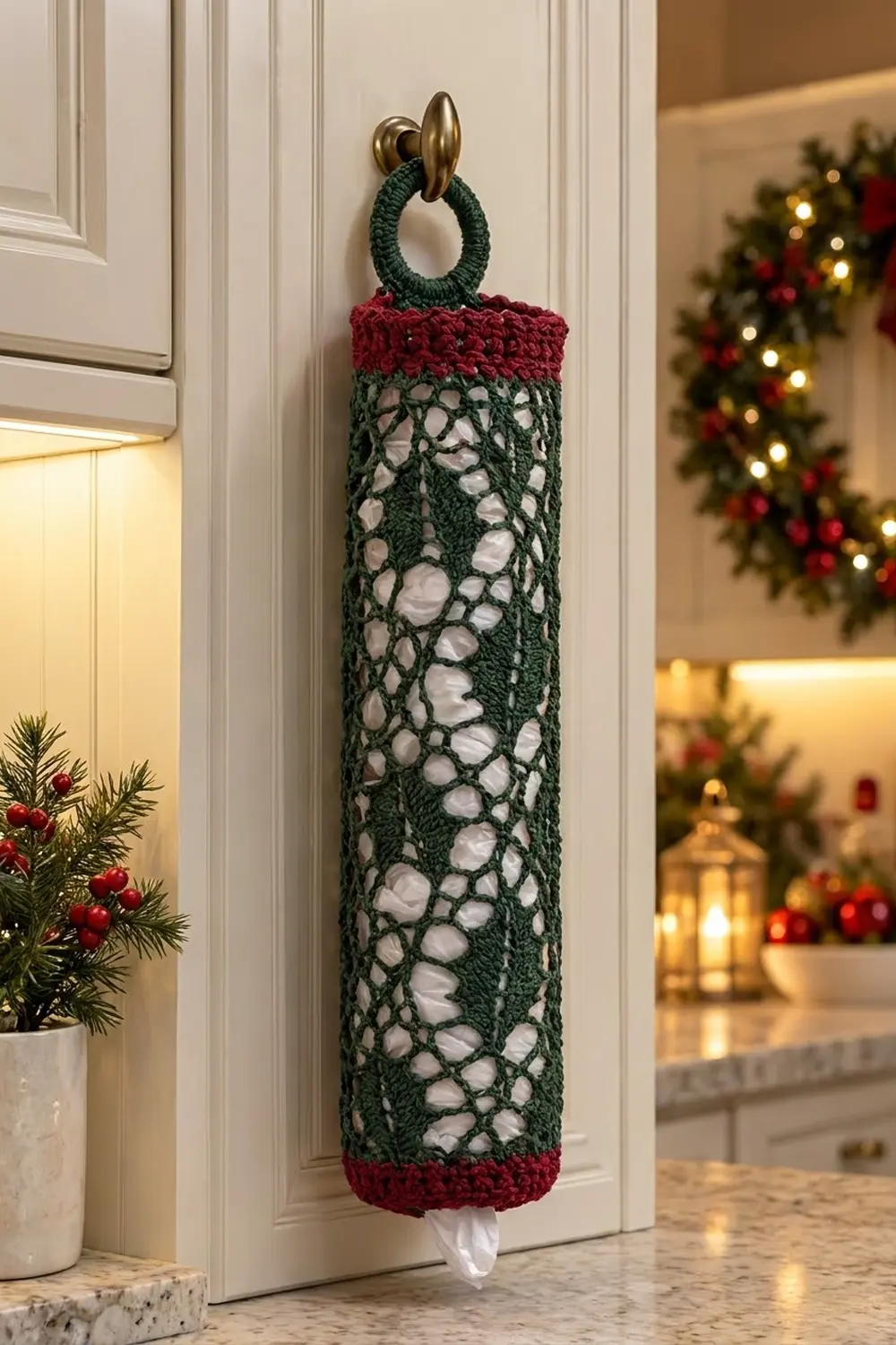 A crocheted door handle holder with green lacy fabric, red trim, and brass hook in a holiday-decorated home.