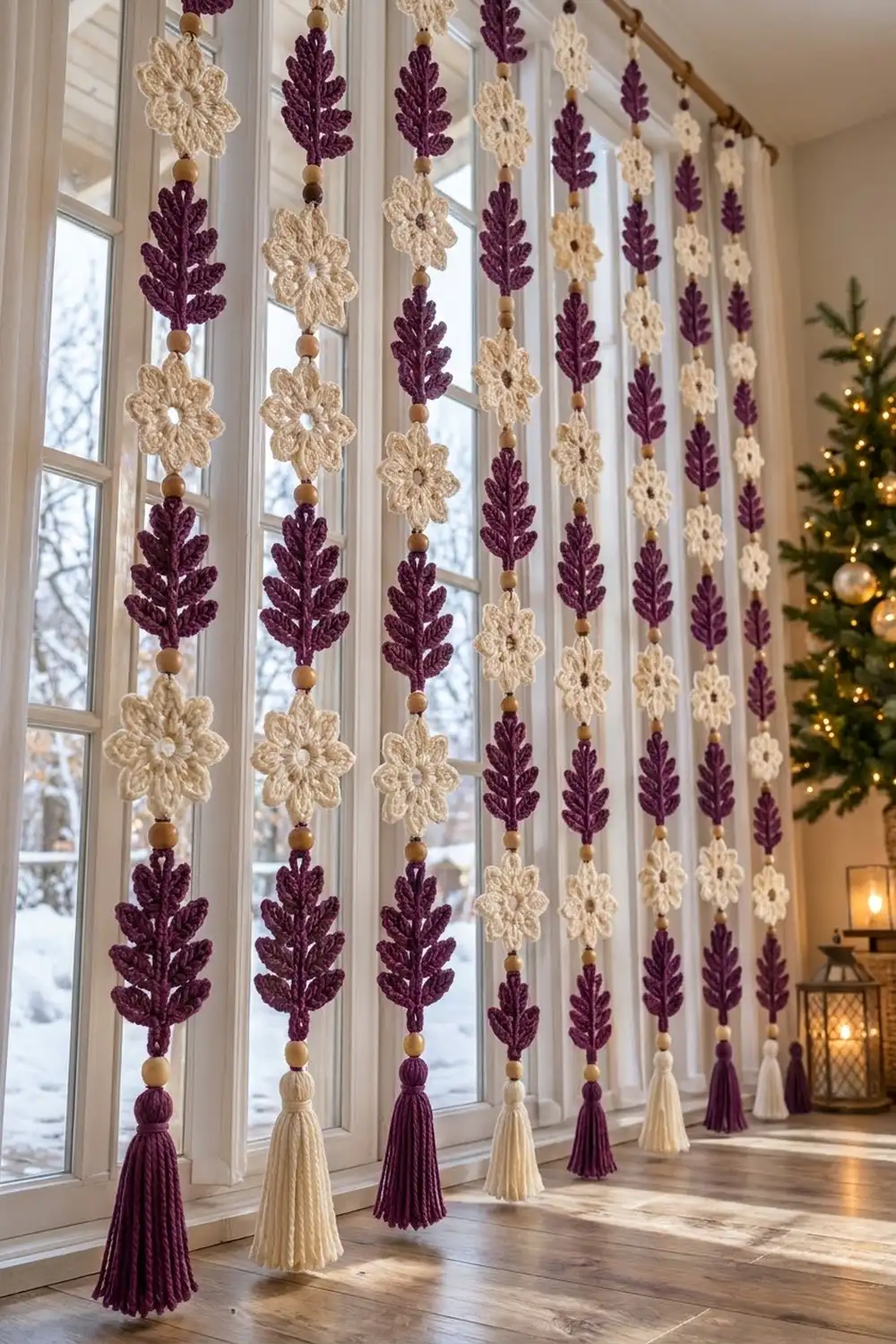Crocheted window curtains with alternating purple and cream flowers and leaf motifs, adorned with wooden beads and tassels.