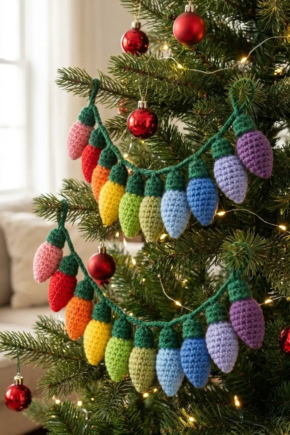 Colorful crocheted egg garland draped on a Christmas tree with red ornaments and warm lights.